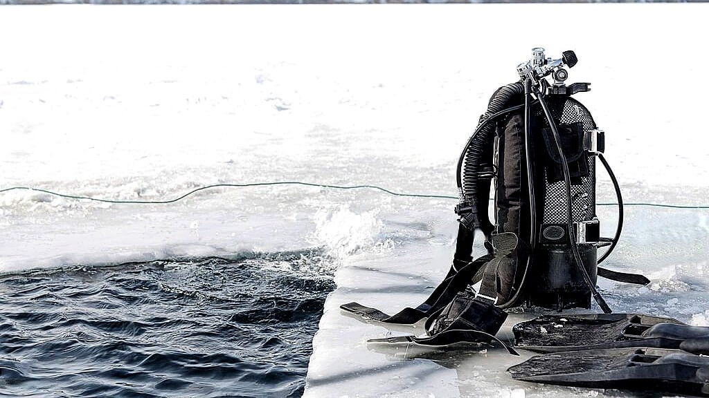 Equipment for ice diving, including drysuits and diving flags.